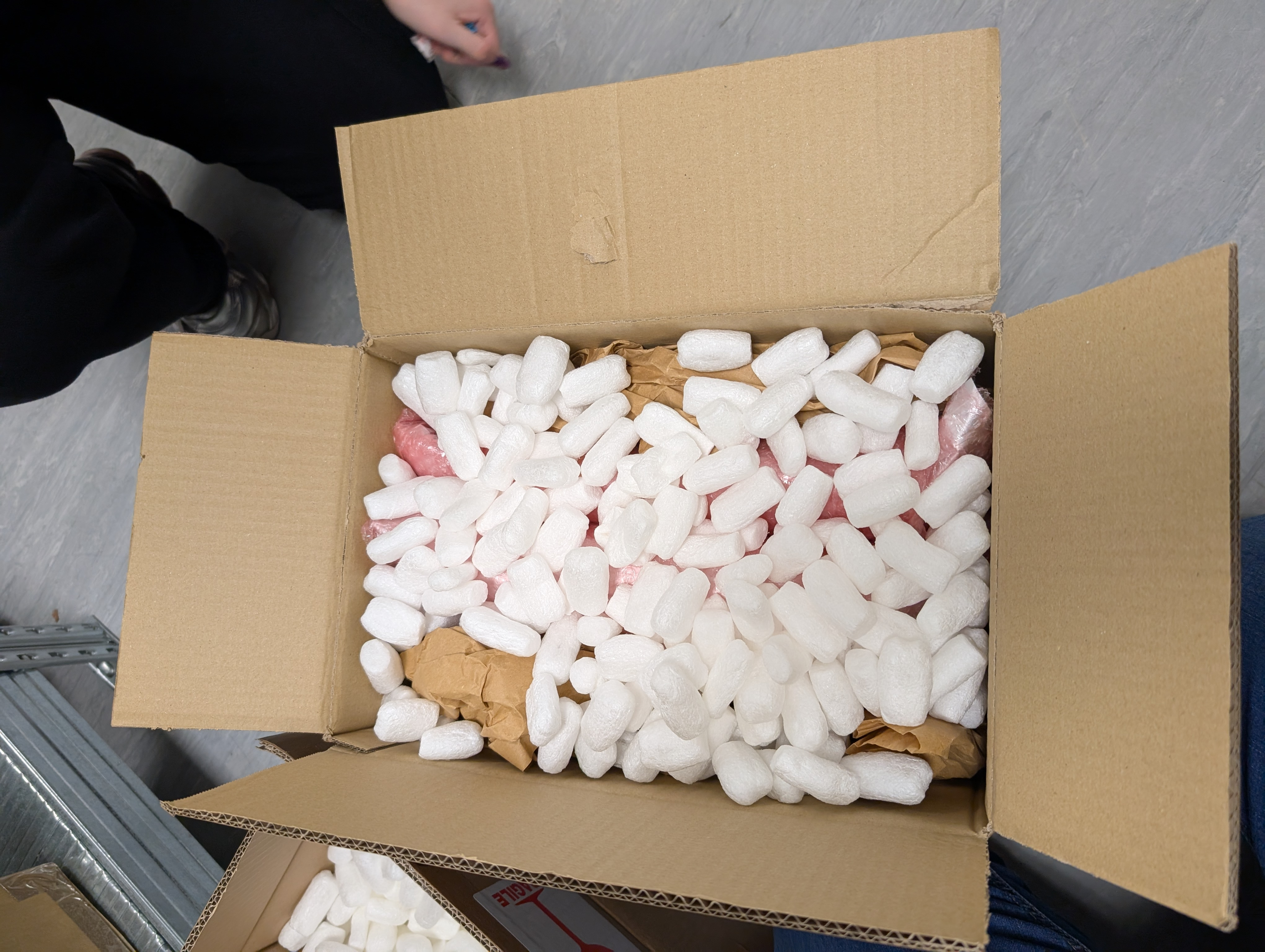 A bubble wrapped sealed hybrid panel box placed in a cardboard box with plenty of padding.